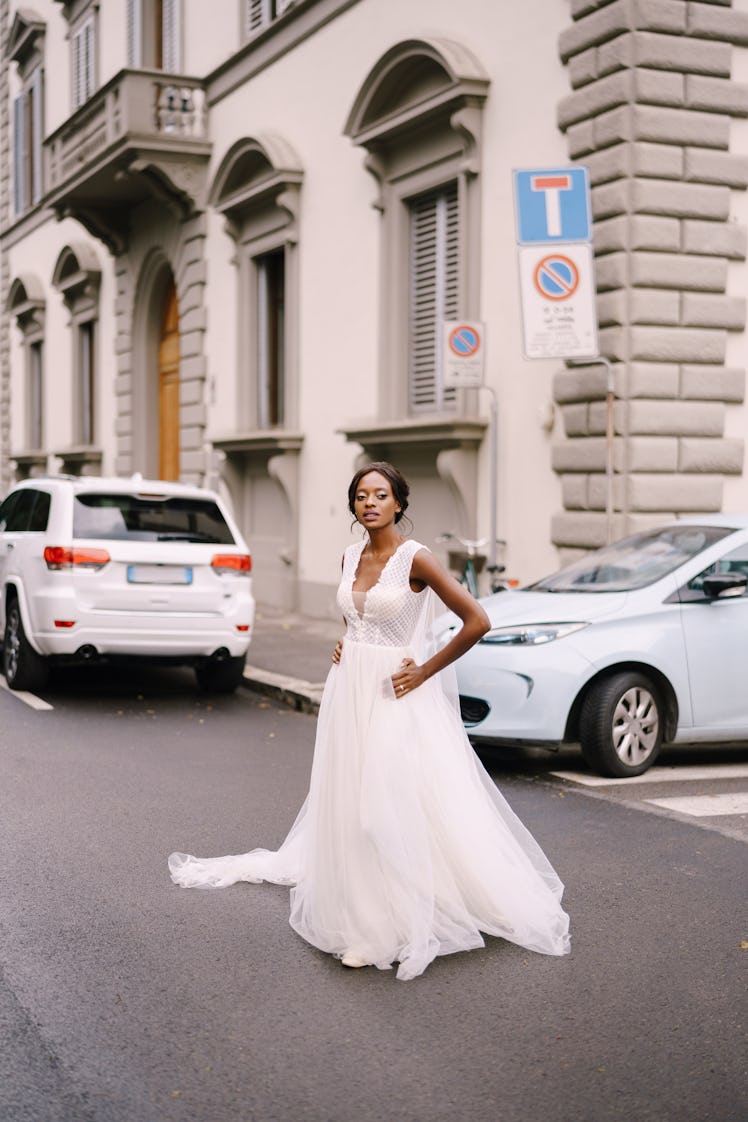 Young bride walking the streets on the wedding date to avoid in 2023, according to astrology.