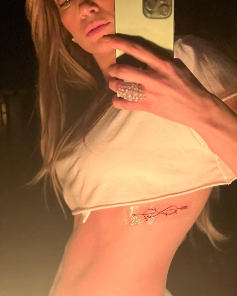 Jennifer Lopez rib tattoo for Ben Affleck infinity sign with cursive and arrow