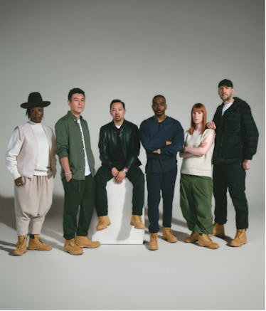 a group of creatives standing in a grey room