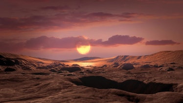 image of the rocky surface of a planet, with water in the distance and a dim sun hanging low in a re...