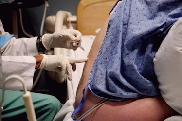 A pregnant person getting an epidural.