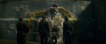 Three women stand in front of one human's mutated, fungus-ridden corpse in Annihilation