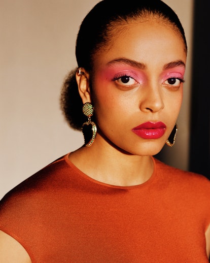 A model wearing pink eyeshadow and red lip