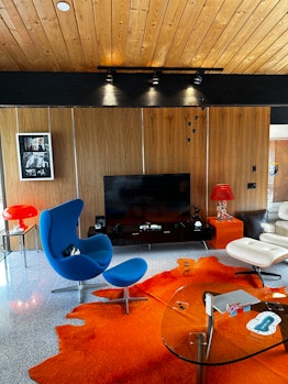 A room containing an Arne Jacobsen egg chair, Isamu Noguchi coffee table, and a Charles and Ray Eame...