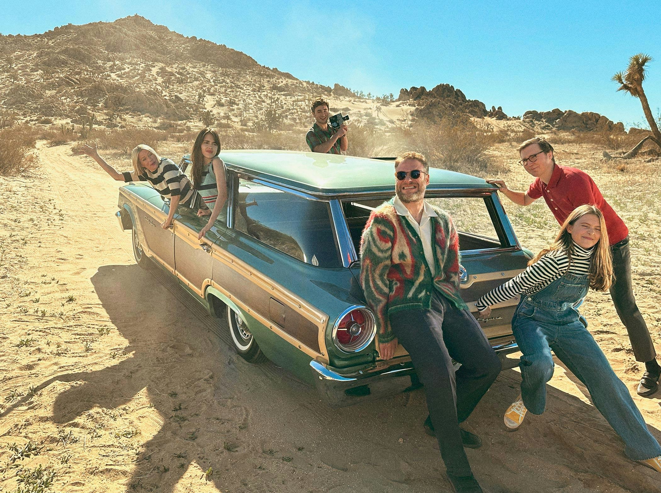 Michelle Williams wearing a black & white strip sweater. Seth Rogan wears a colorful cardigan sweate...