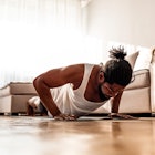 A man doing push-ups in his living room.