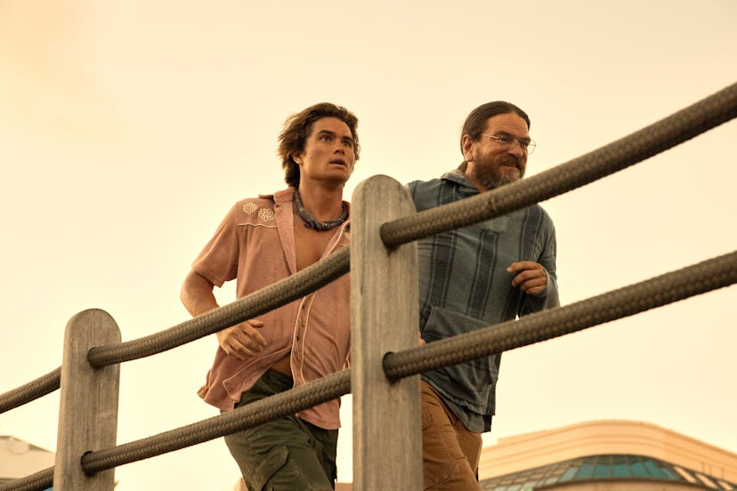 Chase Stokes as John B, Charles Halford as Big John in ‘Outer Banks’ Season 3, via Netflix’s press s…