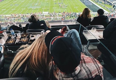 Chase Stokes and Kelsea Ballerini at football game