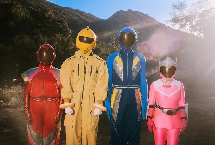 Models wearing various color costumes and helmets that portrays the Power Rangers.