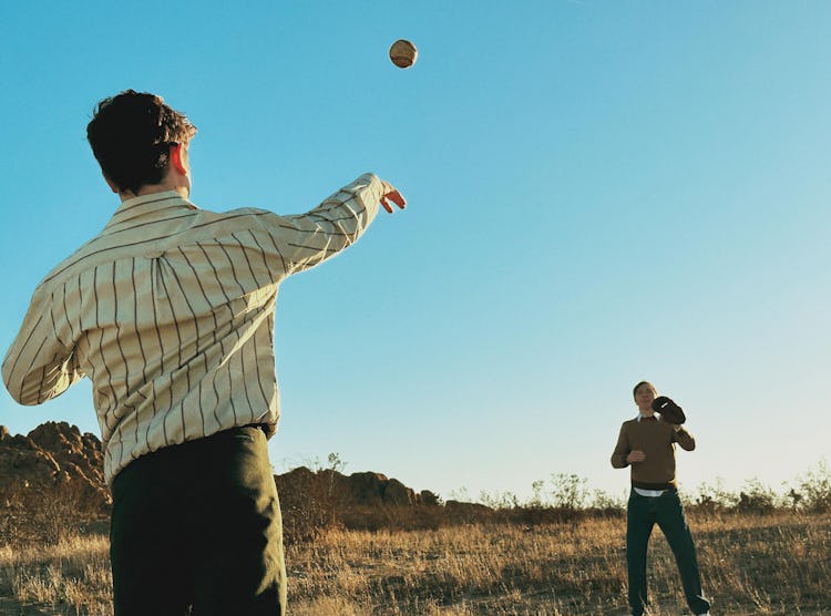 LaBelle and Paul Dano are playing catch with a baseball.