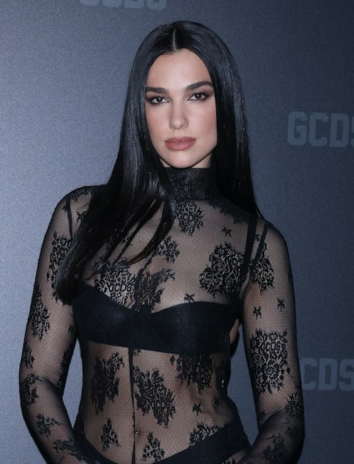 dua lipa shows of thong and bra in see-through lace dress at milan fashion week 2023