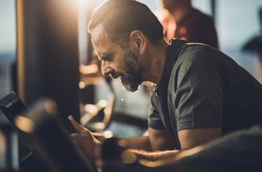 Close up of a man cycling at the gym.