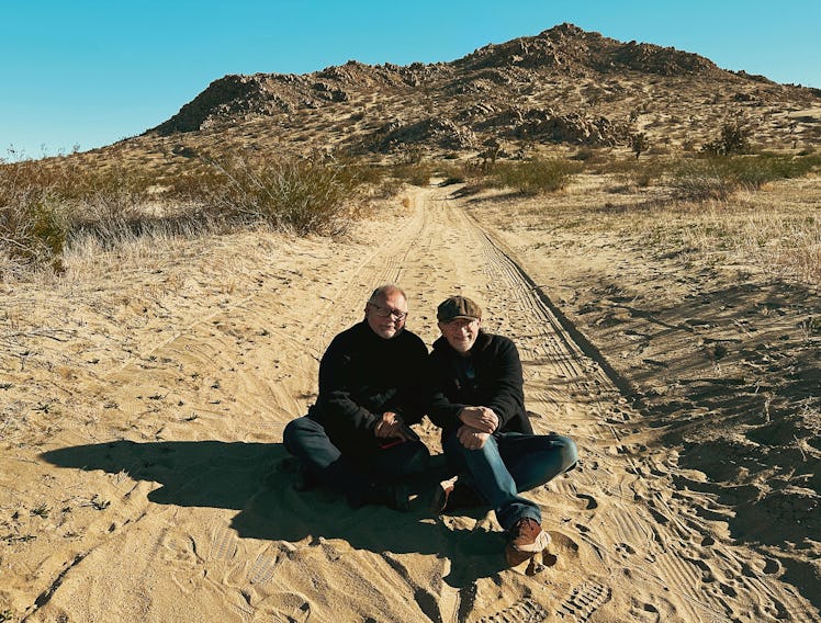 Director Steven Spielberg (right) with Director of Photography Janusz Kaminski sitting on a hill in ...