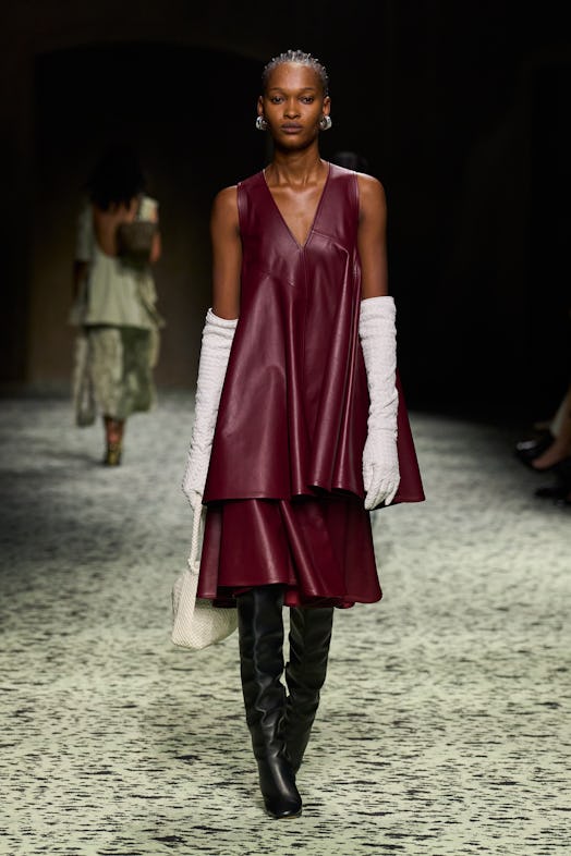 model in burgundy leather top and skirt