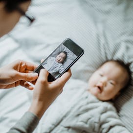 Parent taking photo of their baby with a smart phone