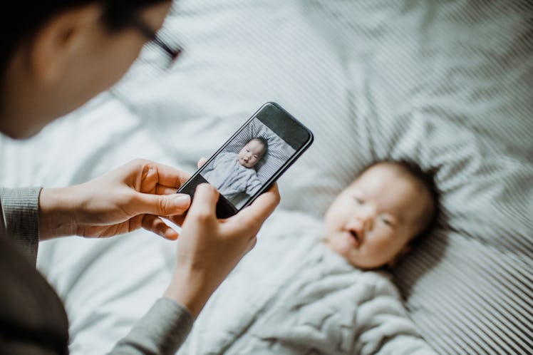 Parent taking photo of their baby with a smart phone