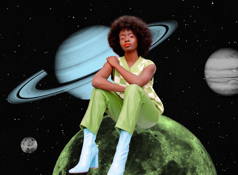 Young woman sitting on a planet after reading her March 2023 horoscope.