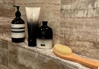 High end hair products on a shower shelf