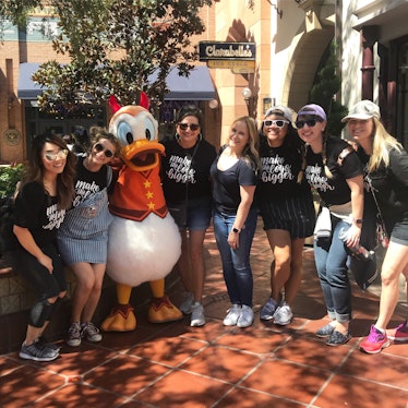 A group enjoy a VIP tour at Disneyland with Donald Duck. 