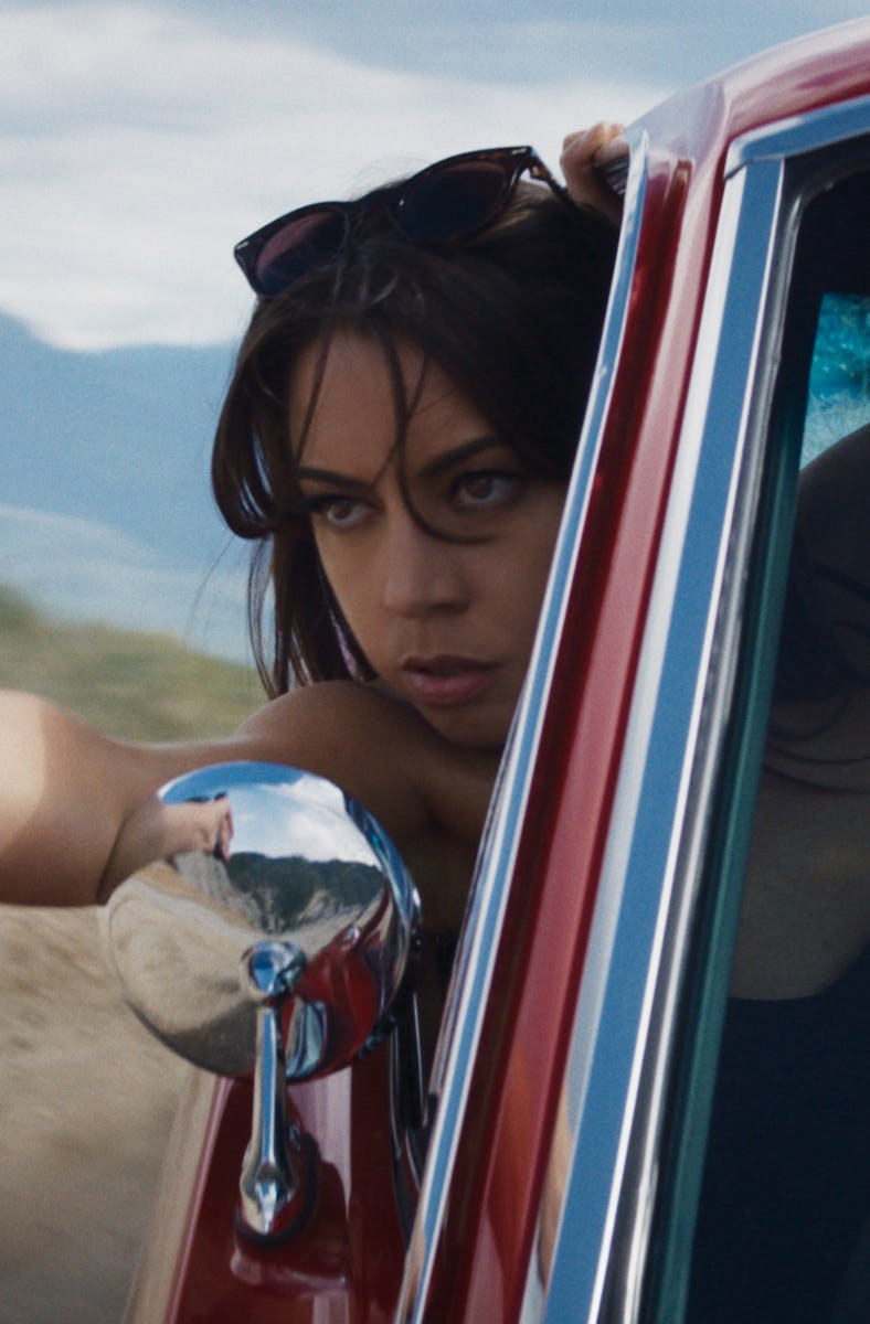 Aubrey Plaza points a gun out a car window in Operation Fortune: Ruse de Guerre