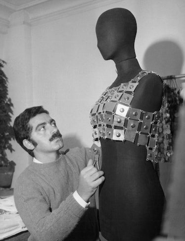 Paco Rabanne in his studio with a mannequin wearing a metal top