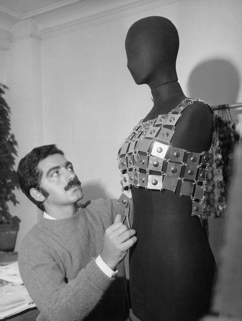 Paco Rabanne in his studio with a mannequin wearing a metal top