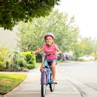 Unmotivated Kid Working Out - Riding a bicycle down the street