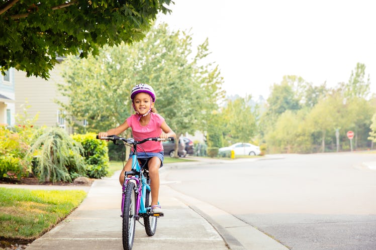 Unmotivated Kid Working Out - Riding a bicycle down the street
