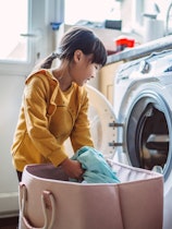 A young girl does laundry