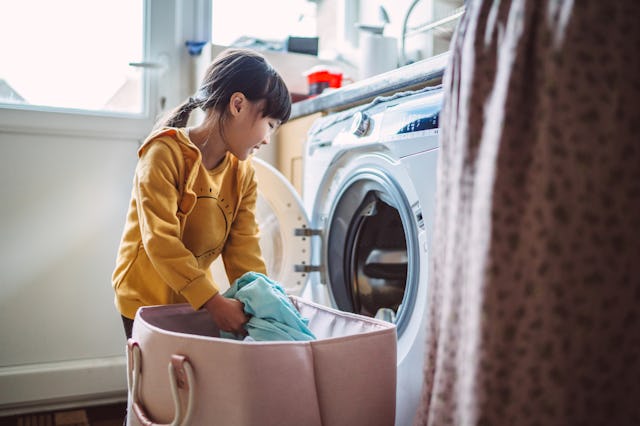 A young girl does laundry