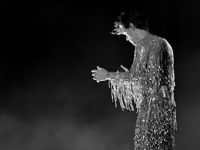 Harry Styles wearing a silver sequin fringe catsuit at the 2023 Grammy Awards.