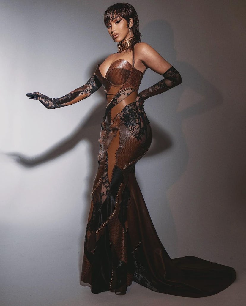 Cardi B mullet wet hair with brown leather dress