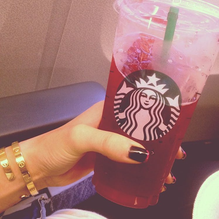 Kylie Jenner shows her go-to Starbucks order, which is a passion tea lemonade with raspberry. 