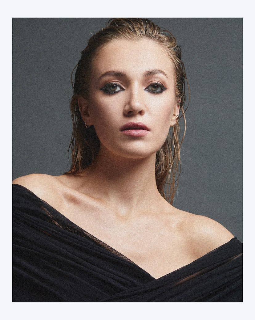 A portrait of Tilly with wet hair and a black dramatic blouse