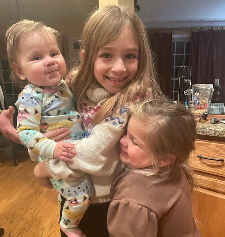 The author's three girls hugging each other.