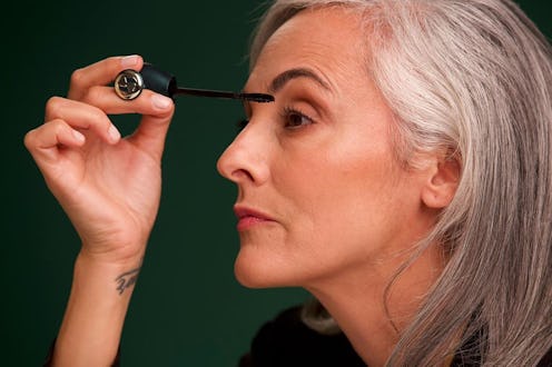 A woman applying mascara with an accessible applicator