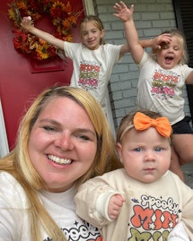 The author with her three girls in Halloween shirts.