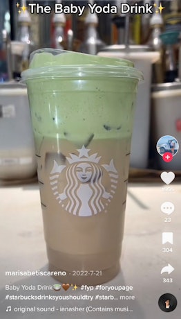 A barista makes a Baby Yoda drink from Starbucks inspired by 'The Mandalorian.' 