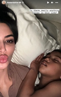 Kim Kardashian and Saint West cuddled together in a sweet moment shared on Instagram.