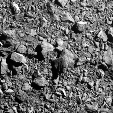 rocks strewn across an asteroid in a close up image of the surface