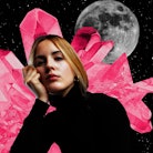 Young woman with crystals and a moon behind her to show that your 2023 astrological new year horosco...