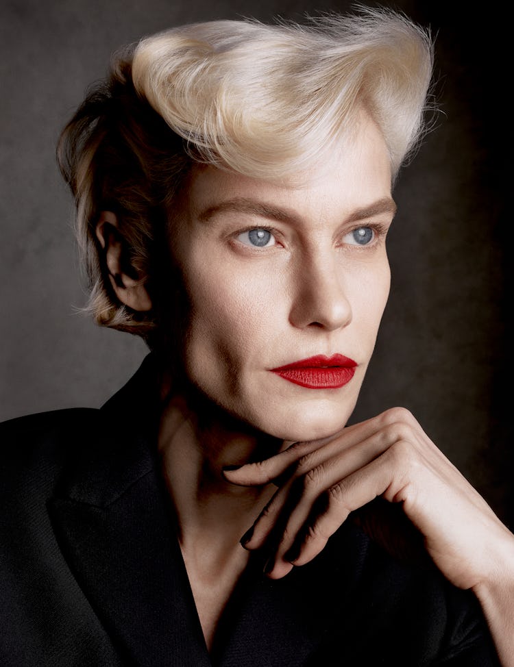Model Delfine Bafort wears a black jacket and red lipstick.