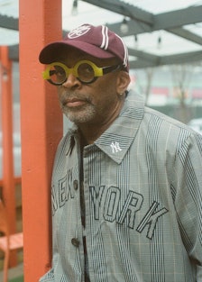 Spike Lee wears a Kith & MLB for New York Yankees coat; Polo Ralph Lauren for Morehouse College cap ...