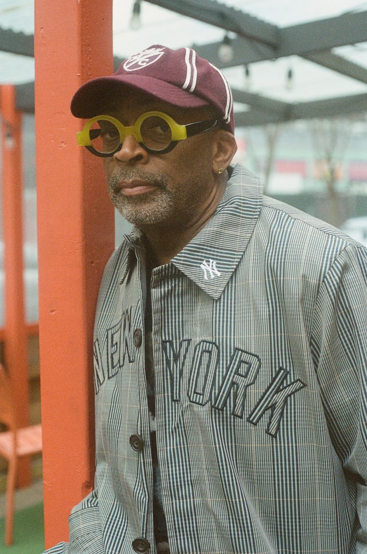 Spike Lee wears a Kith & MLB for New York Yankees coat; Polo Ralph Lauren for Morehouse College cap ...