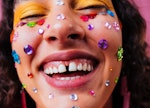 A young woman with stickers on her face, emphasizing her positive spring equinox 2023 horoscope.