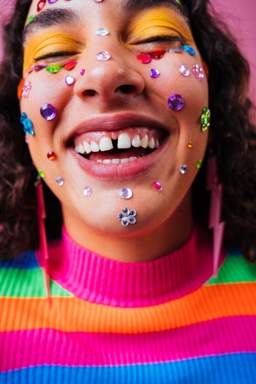 A young woman with stickers on her face, emphasizing her positive spring equinox 2023 horoscope.