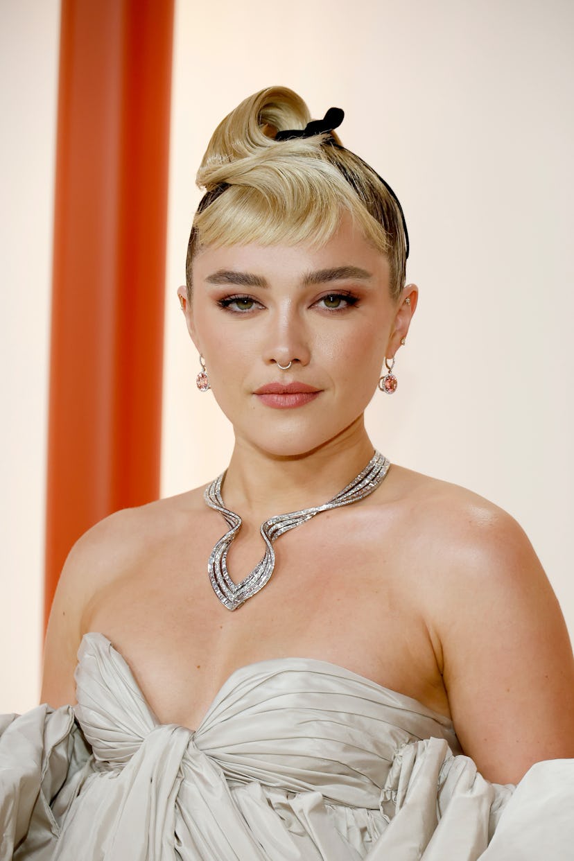 the actress florence pugh wearing a gown and glittering diamond jewelry