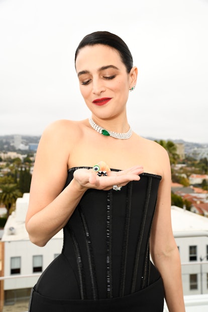 Jenny Slate holding Marcel the Shell in her hand