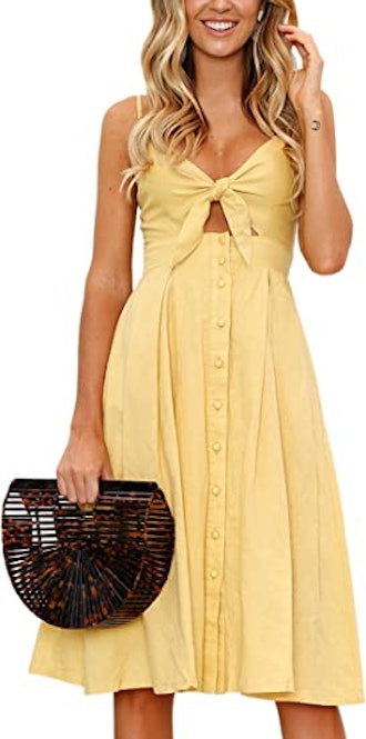 If you're looking for cute dresses, consider this swing dress with a tie-front design.