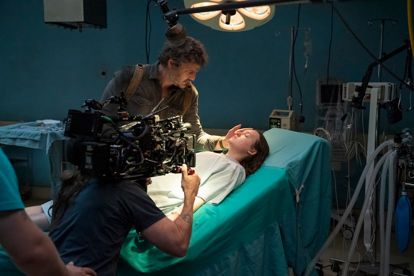 A behind-the-scenes photo of Pedro Pascal (Joel) and Bella Ramsey (Ellie) filming 'The Last of Us' S...